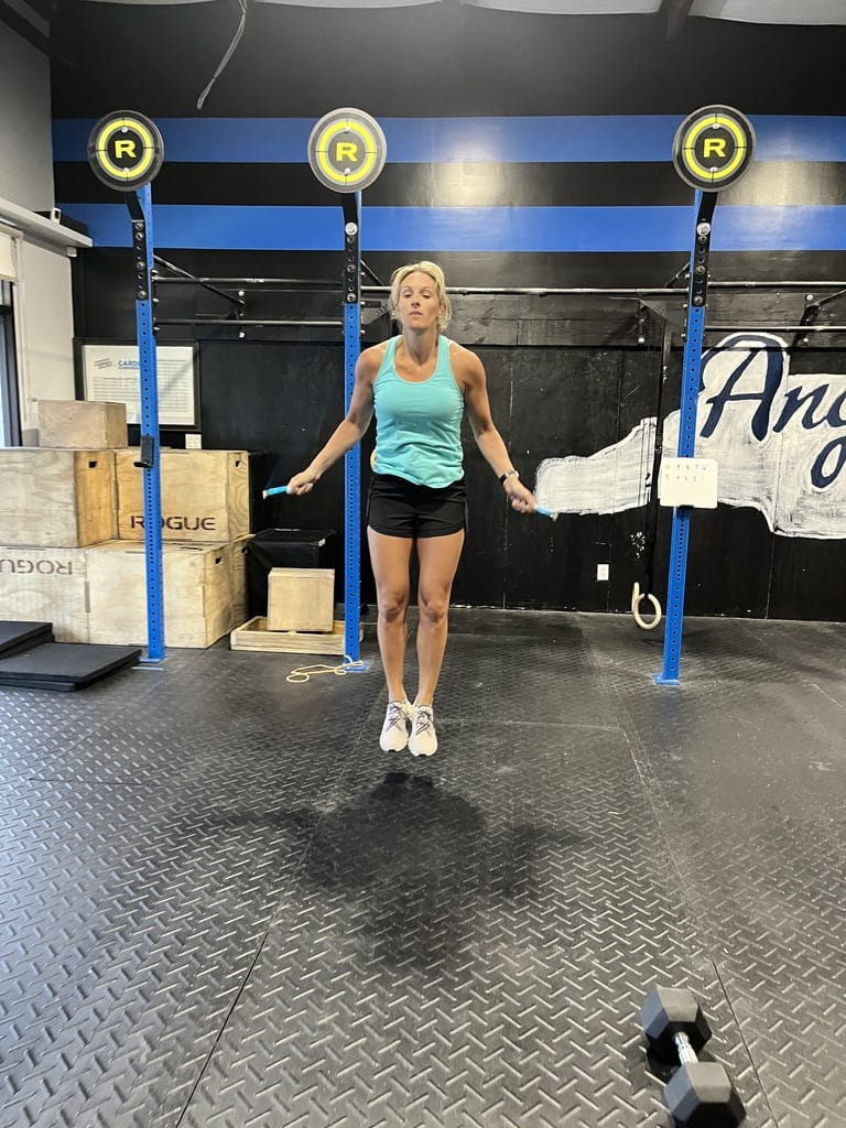 Woman jumping during Crossfit workout wod